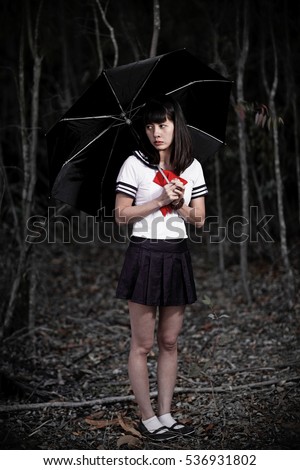 Beautiful And Sexy Asian Japanese Schoolgirl In Uniform Holding A Black Umbrella Lost In A Dark Beautiful And Sexy Asian Japanese Schoolgirl In Uniform Holding A Black Umbrella Lost In A Dark