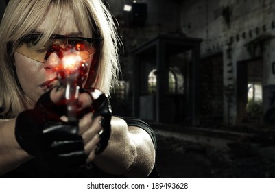 Beautiful sexy blonde girl with gun