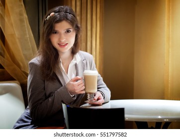 Beautiful sexy brunette woman in restaurant drinking coffee - Shutterstock ID 551797582
