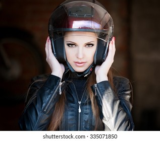 Beautiful Sexy Elegance Haired Hair Woman Driver, Has Happy Fun Cheerful Smiling Face, Black Leather Jacket, Motorcycle Helmet, Brown Smokey Eyes. Has Slim Sport Body. Portrait Street Urban. 