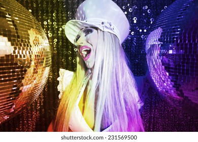 A Beautiful Sexy Female Drag Artist Dancing And Posing In Character In A Disco/club Setting 