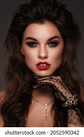 Beautiful sexy girl with bright make up, red lips, curl hair. Beauty face.