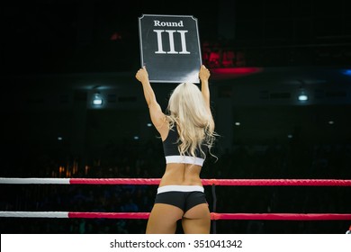 Beautiful Sexy Girl In Ring During Competition In MMA And Boxing. In His Hands Sign With Round Number
