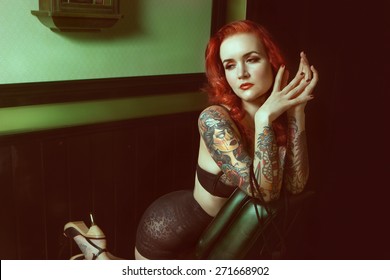 Beautiful sexy glamorous girl with tattoos.red.