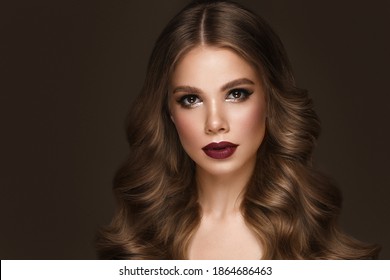 Beautiful sexy woman with classic make-up, fashion hair and red lips. Beauty face. Photo taken in the studio