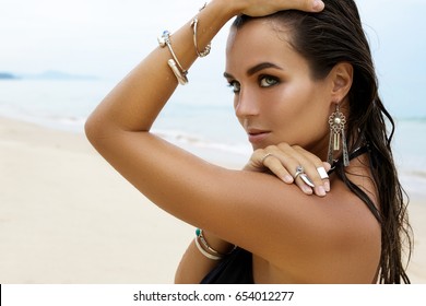 Beautiful And Sexy Woman On The Beach Wearing Silver Jewelry