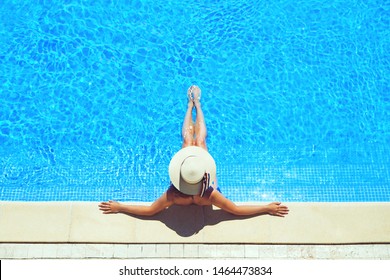 Beautiful  Sexy Woman In Sun Hat Taking Sun Bath Near Swimming Pool.
