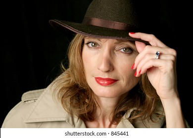 A Beautiful, Sexy Woman Wearing A Trench-coat And Fedora Hat.