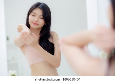 Beautiful Sexy Young Asian Woman Looking Mirror Applying Cream On Elbow And Message, Beauty Girl Applying Body Lotion Skin Care For Health And Soft Hydration, Treatment And Cosmetic With Moisturizer.