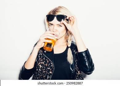 Beautiful and sexy young blond woman drinking beer, not isolated on white background