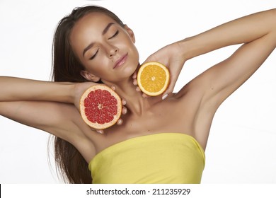 Beautiful Sexy Young Woman With Perfect Healthy Skin And Long Brown Hair Day Makeup Bare Shoulders Holding Orange Lemon Grapefruit Healthy Eating Organic Food Diet Weight Loss