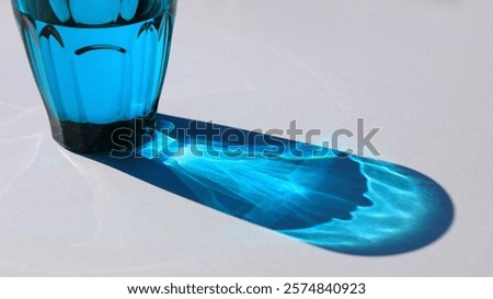 Beautiful shadows and light reflections passing through the blue glass water