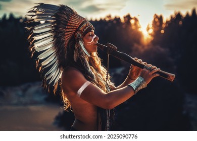 beautiful shamanic girl playing on shaman flute in the nature. - Shutterstock ID 2025090776