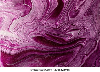 Beautiful shimmer purple and silver stains of liquid nail polish.Stripy paint texture.Nail lacquer flow background in fluid art technique.Minimalism concept.Copy space,horizontal photography.