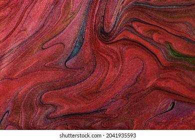 Beautiful shimmer stains of liquid nail polish.Red,green and blue colors.Stripy paint texture.Nail lacquer flow background in fluid art technique.Minimalism concept.Copy space,horizontal photography.