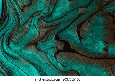 Beautiful shimmer turquoise stains liquid nail polish Stripy paint texture Nail lacquer flow background in fluid art technique Minimalism concept Copy space horizontal photography 