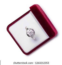 Beautiful Shiny Ring With Big Gem Diamond In Rich Red Velvet Box Proposal On White Background Isolation Top View