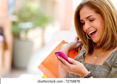 Beautiful Shopping Woman Texting On Her Cell Phone