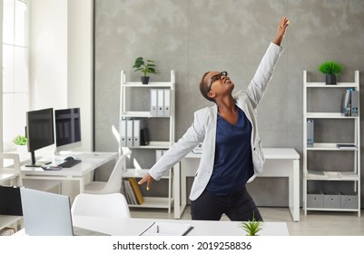 Beautiful Short Haired Young Black Woman Has Lots Of Energy For Active And Productive Work Day. Happy Energetic African American Corporate Worker Or Business Lady In Suit Dancing In Modern Office