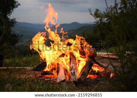 A beautiful shot of a bonfire burning on the field 