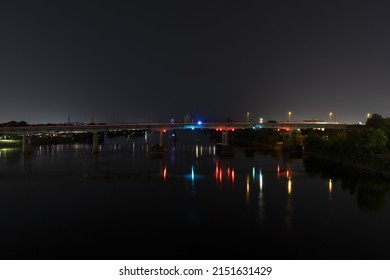 A Beautiful Shot Of A Bridge With Colorful Lights Over The River At Night In Little Rock, Arkansas, United States