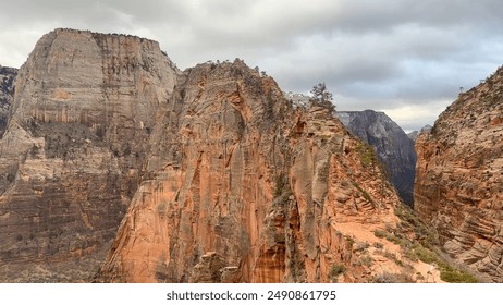 Beautiful shot of the famous Angels Landing rock formation and narrow hiking trail in Zion National Park, Utah, USA on a cloudy, stormy day. - Powered by Shutterstock