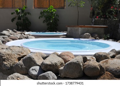 A Beautiful Shot Of Small Round Inground Swimming Pools Under The Sunlight