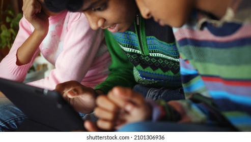 A Beautiful Shot Of South Asian Children Playing A Game With Tablet