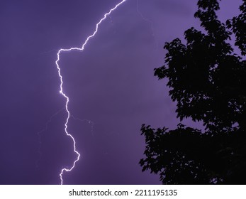 A Beautiful Shot Of Striking Lightning In A Dark Purple Sky