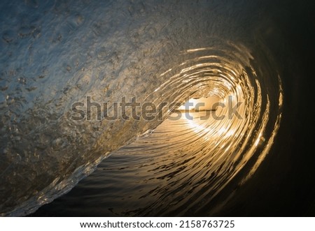 A beautiful shot of of a sunset inside surf waves