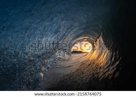 A beautiful shot of of a sunset inside surf waves