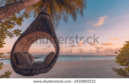 Beautiful silhouette of hammock on palm trees on tropical beach paradise at sunset. Carefree freedom concept, summer nature, exotic shore coast. Tranquil travel landscape. Enjoy life, positive energy
