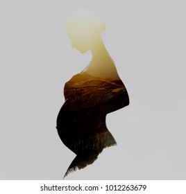 Beautiful silhouette of pregnant woman combined with a mountains during the sunrise. Double exposure, isolated on a white background. 