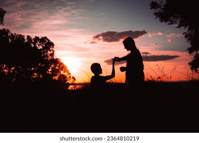 Beautiful silhouettes of two dancers at sunset. silhouette of brother and sister dancing at sunset - Shutterstock ID 2364810219