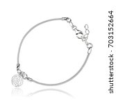 beautiful silver chain bracelet with round lacy pendent on the white background