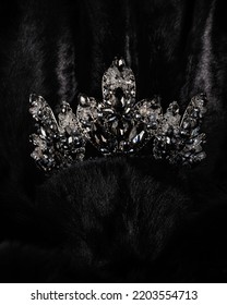 Beautiful Silver Crown With Black Stone For Miss Beauty Pageant On Black Shiny Background, Close-up