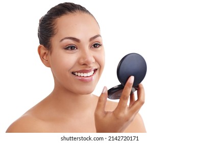 Beautiful Skin Matched With A Beautiful Smile. Shot Of A Beautiful Woman Using A Compact Mirror Isolated On White.