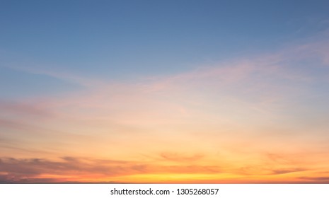 Beautiful sky painted by the sun leaving bright golden shades.Dense clouds in twilight sky in winter evening.Image of cloud sky on evening time.Evening sky scene with golden light from the setting sun - Shutterstock ID 1305268057