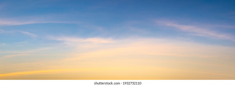 Beautiful sky painted by the sun leaving bright golden shades.Dense clouds in twilight sky in winter evening.Image of cloud sky on evening time.Evening sky scene with golden light from the setting sun - Shutterstock ID 1932732110