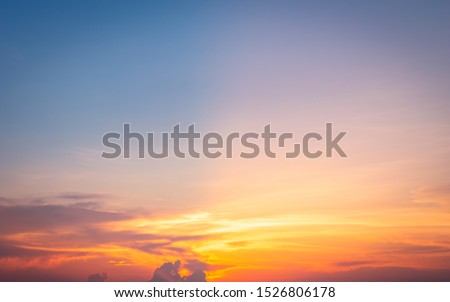 Beautiful sky painted by the sun leaving bright golden shades.Dense clouds in twilight sky in winter evening.Image of cloud sky on evening time.Evening sky scene with golden light from the setting sun