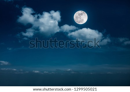Beautiful skyscape. Landscape of night sky with clouds and bright full moon. Serenity nature background, outdoor at nighttime with moonlight. The moon taken with my own camera.