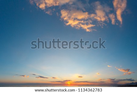 Similar – Foto Bild Wolken mit Sonnenstrahlen vor bergigen Vordergrund