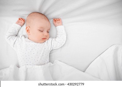 Beautiful sleeping baby in bed