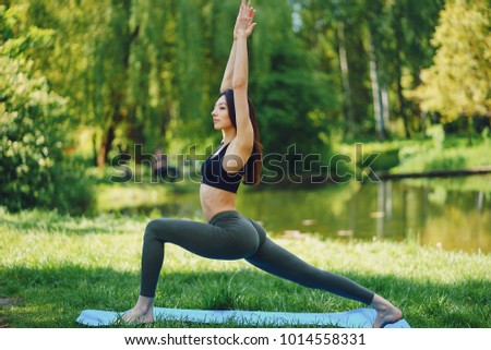 Similar – Active slim young woman doing yoga by the lake