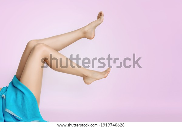 beautiful slender legs of a young\
woman on a pink background copy the space. the concept of body care\
and depilation, prevention of cellulite and varicose\
veins