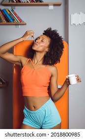 Beautiful Slim Black Woman Eating Yogurt At Home. Fit Afro Hairstyle Female Taking Healthy Snack.