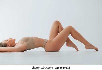 Beautiful slim body type. Woman in underwear is posing in the studio.