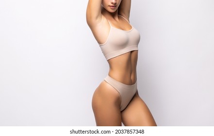 Beautiful slim body of woman in lingerie on white background