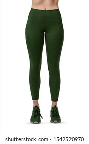 Beautiful slim female legs in green sport leggings and running shoes isolated on white background. Concept of stylish clothes, sports, beauty, fashion and slim legs