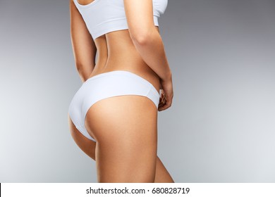 Beautiful Slim Woman Body. Closeup Of Healthy Girl With Fit Body, Soft Skin, Tight Hips And Firm Buttocks In Bikini Underwear. Perfect Female Body In Shape With Sexy Back And Big Butt. High Resolution